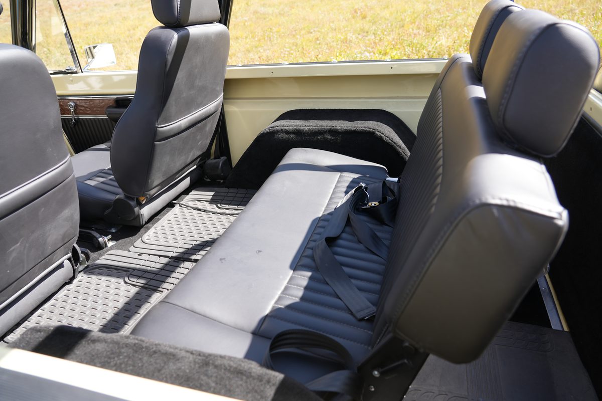 Matching black rear bench seat with seat belts, black carpeting and rubber floor mats