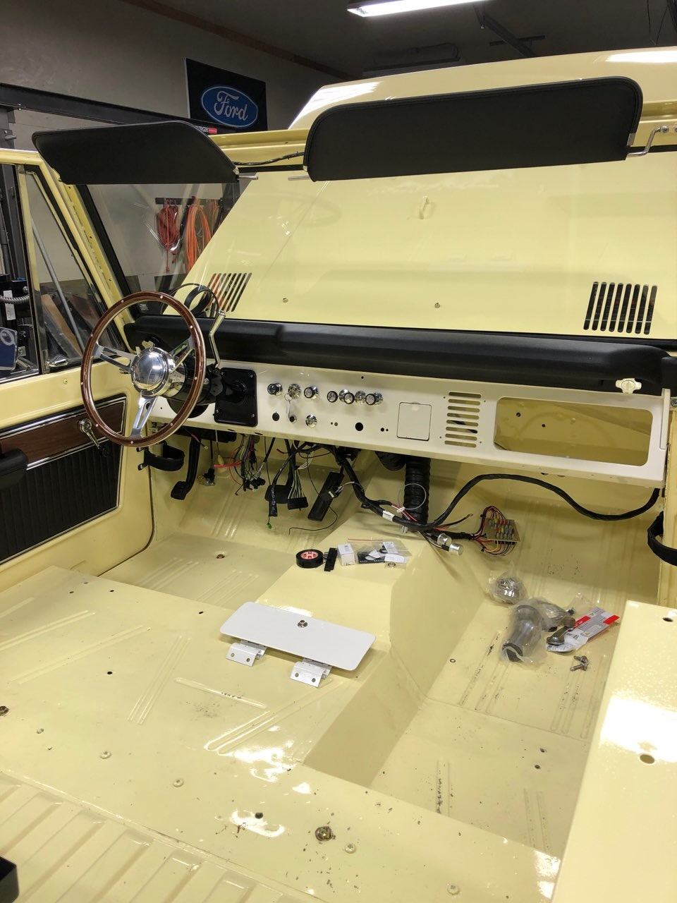 Restored dashboard with wood-rim steering wheel during wiring