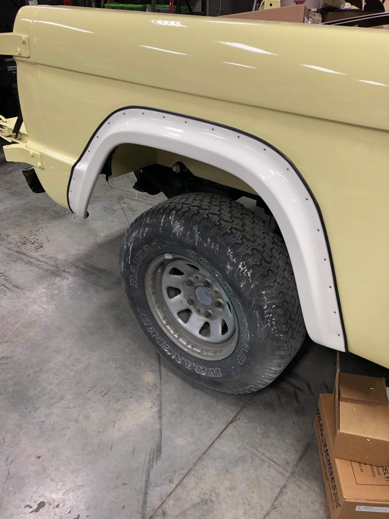 Fender flare, black wheel and all-terrain tire fitted to fresh paint