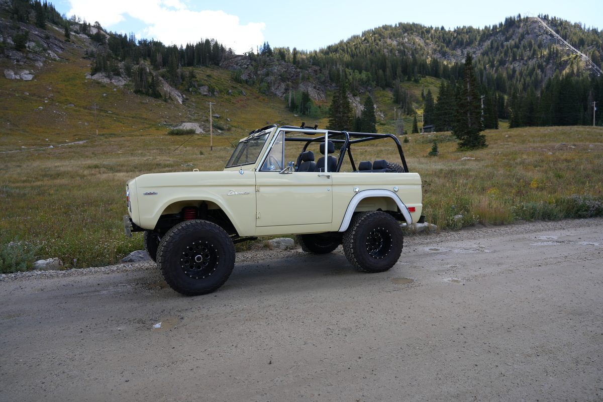 Wide driver-side profile with the mountainside rising behind